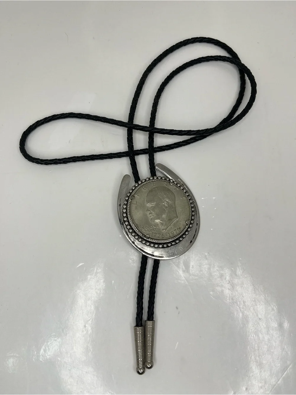 Black Braided Leather Bolo Tie with Silver Horseshoe and Coin Medallion